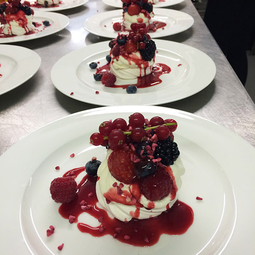 Individual summer fruit pavlova with freeze dried raspberry pieces